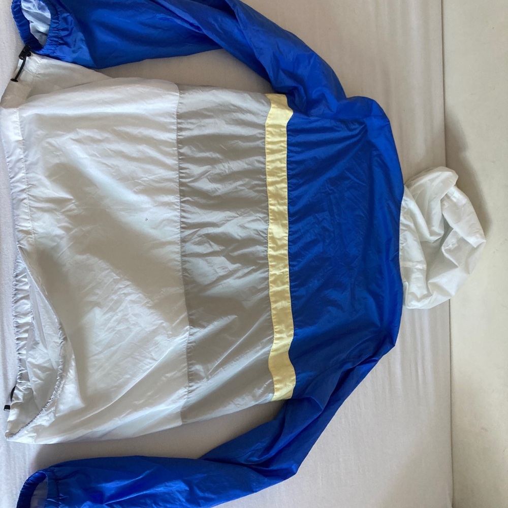 This is a tight fitting, gently used XL Pink+Dolphin Windbreaker.